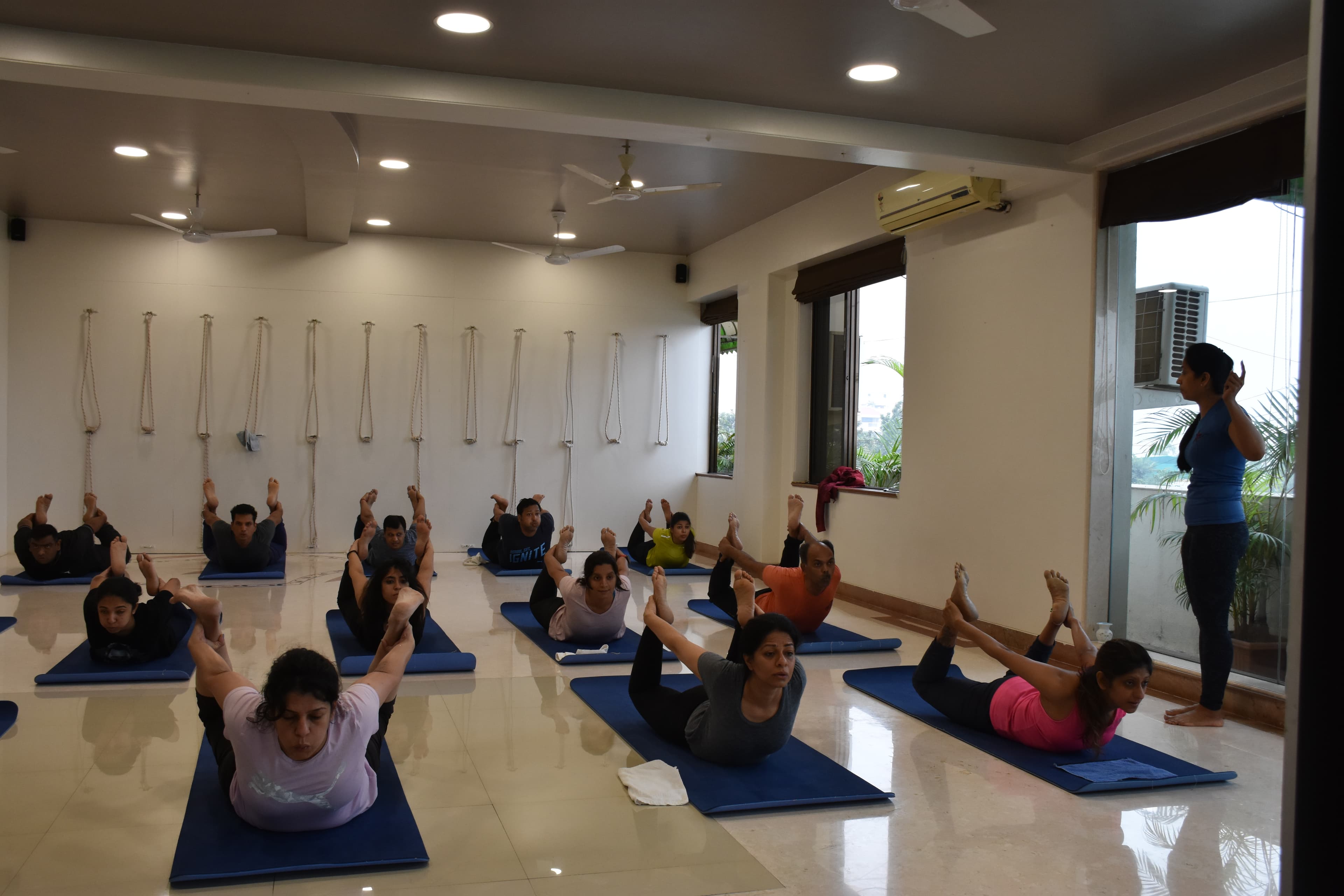 Power Yoga class holding Shalabhasana at the Biorhythm studio